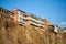 Old architecture of Tbilisi. Dense development of a residential building on a cliff by the river