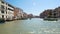 Old architecture of Venice streets seen from canal, sunlight sparkling on water