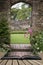 Old archway in old English country garden landcape in Spring wit