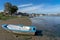 old artisanal wooden fishing boat in a phase of degradation on top of the mud at low tide of the Tagus River