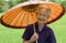 Old Asian woman with parasol