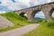 The old Austrian stone railway bridge viaductand bicycle near it