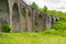 The old Austrian stone railway bridge viaductand bicycle near it