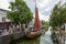 An old authentic fisher boat in a canal in the city center of De