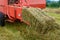 Old bale press, hay harvesting in the village for cattle, press work close up