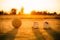 An old ball with the shoes for street soccer football under the sunset ray light.