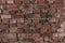 Old bare brick wall with red bricks close up