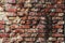 Old bare brick wall with red bricks close up