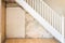 Old bare wall and stairs during renovations.