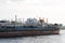 The old barge ship is anchored at an abandoned shipyard, in the harbor