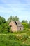 Old barn with collapsed roof of corrugated asbestos cement sheet