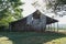 An old barn filled with round hay bales.