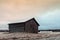 Old Barn On The Frosty Fields With White Bales