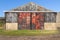 Old barn with metal doors, rusty and red