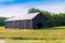 Old barn near pond. Country landscape