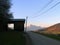 Old barn and a road, mountain village, alpine sunset, France