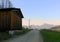 Old barn and a road, mountain village, alpine sunset, France