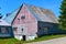 An old barn in rural NH with a facade in weathered red and blue paint