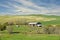 Old barn stands in a green field