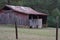 Old Barn with wire fence around it.