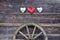 Old barn wooden wall with hearts and carriage wheel