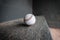an old baseball sitting in a corner on the floor by itself