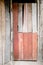 Old and basic red painted wood door of old traditional wooden thai house