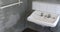 Old bathroom sink and faded wall pan view in country house