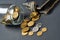 Old battered empty wallet and coins in glass jar on concrete desk