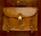 Old battered, leather briefcase wood background
