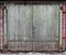 Old battered wooden gate is padlocked