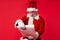Old bearded Santa Claus reading Merry Christmas wishlist paper roll