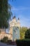 An old beautiful church behind monument to World War Two on background of blue sky. Religious architecture of Russia.