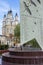 An old beautiful church behind monument to World War Two on background of blue sky. Religious architecture of Russia.