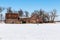 Old beauty, a distressed abandoned wooden barn falling apart captured in winter.