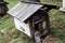 Old beehive on the background of an old house in autumn. Background. Beautiful landscape. Background.