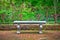 Old bench in formal English garden with ornate wrought iron fence