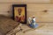 An old Bible, a wooden icon of Saint Nicholas, a wax candle