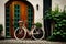 Old bicycle with flowers in front of a door vegetated with ivy Ai generated