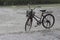 Old bicycle on the street in the pouring rain