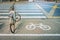 Old bicycle with symbol on bicycle parking lot on roadside