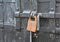 Old big padlock. Closed metal door with old lock