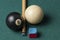 Old billiard ball 8 and stick on a green table. billiard balls isolated on a green background.Black and white