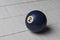 Old billiard ball number 2 blue color on white wooden table background, copy space