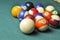 Old billiard balls composition on green pool table