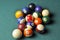 Old billiard balls composition on green pool table