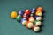 Old billiard balls composition on green pool table