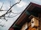 Old birdhouse nailed to the wall of the house on a background of