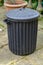 Old black bin with lid in place.