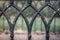 Old black iron fence with vaulted arches